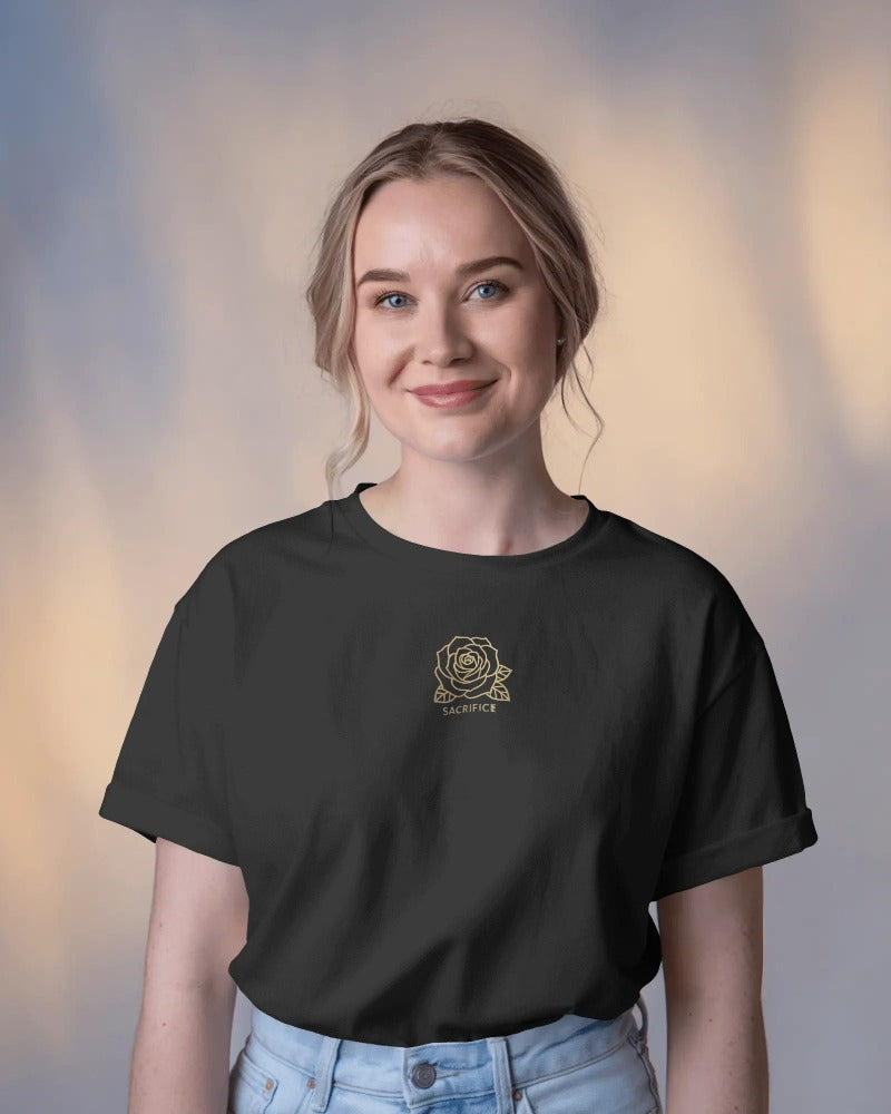 Woman wearing a black t-shirt with a rose design on a blurred background